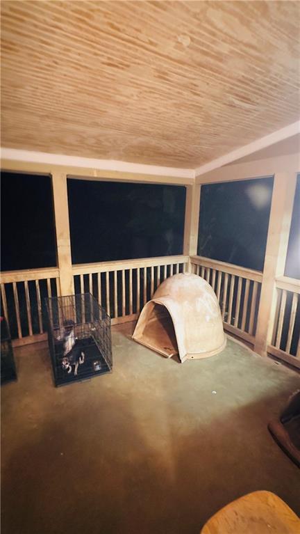 sitting room with carpet and wooden ceiling