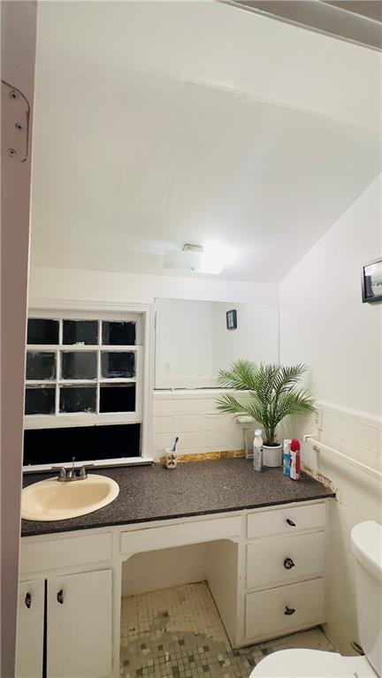 bathroom featuring tile patterned flooring, vanity, and toilet