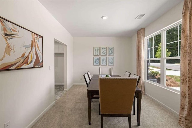 dining space with light carpet