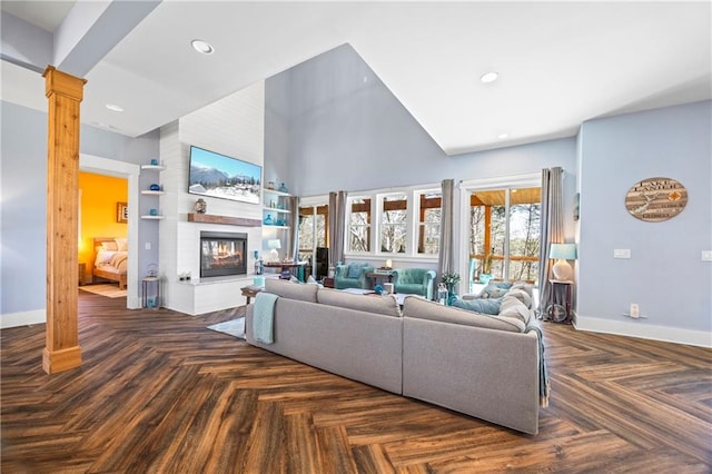 4115 Merritt Dr, Cumming, GA 30041 - living room featuring dark parquet floors, a high ceiling, and ornate columns