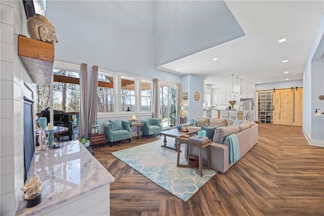 4115 Merritt Dr, Cumming, GA 30041 - living room with dark parquet floors, a barn door, and a high ceiling