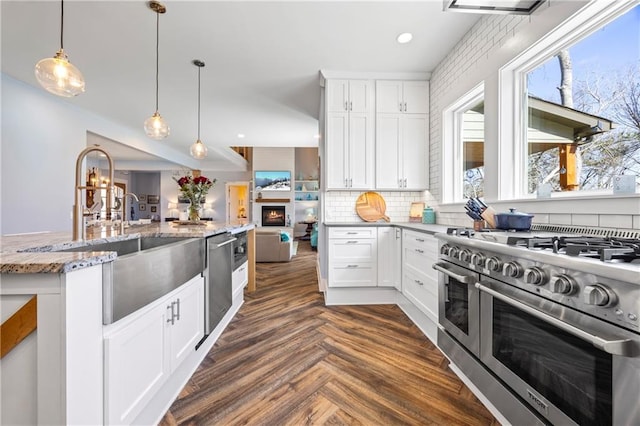 4115 Merritt Dr, Cumming, GA 30041 - kitchen with stainless steel appliances, white cabinetry, dark parquet flooring, and a wealth of natural light