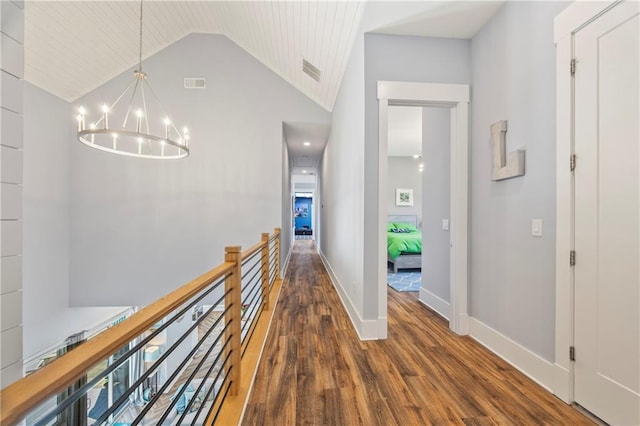4115 Merritt Dr, Cumming, GA 30041 - corridor with vaulted ceiling, a notable chandelier, and dark hardwood / wood-style flooring