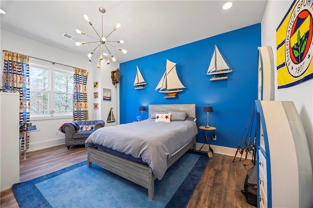 4115 Merritt Dr, Cumming, GA 30041 - bedroom featuring an inviting chandelier and dark hardwood / wood-style flooring
