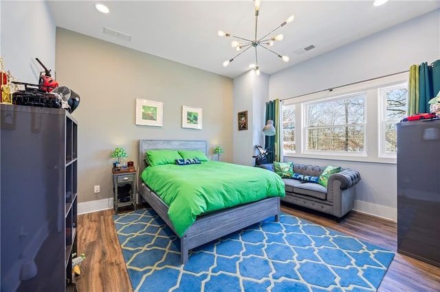 4115 Merritt Dr, Cumming, GA 30041 - bedroom with hardwood / wood-style flooring, fridge, and a chandelier
