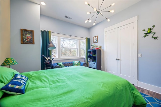 4115 Merritt Dr, Cumming, GA 30041 - bedroom with hardwood / wood-style floors, a chandelier, and a closet