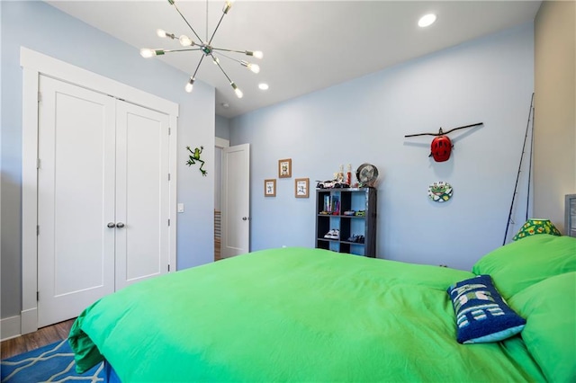 4115 Merritt Dr, Cumming, GA 30041 - bedroom featuring wood-type flooring, a chandelier, and a closet