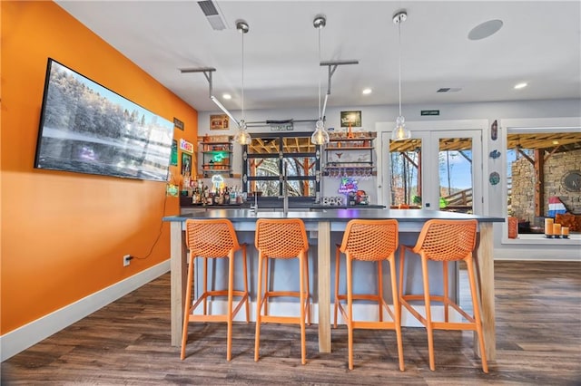 4115 Merritt Dr, Cumming, GA 30041 - bar featuring dark hardwood / wood-style floors and hanging light fixtures