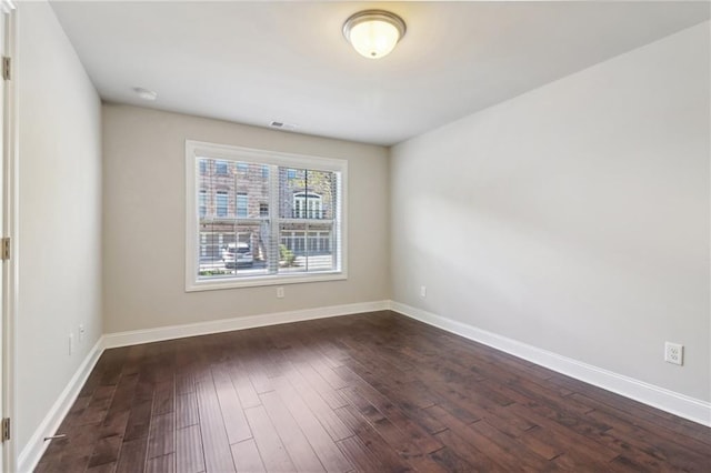 empty room with dark wood-type flooring