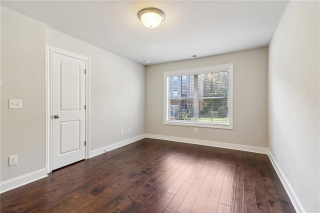 empty room featuring dark hardwood / wood-style floors