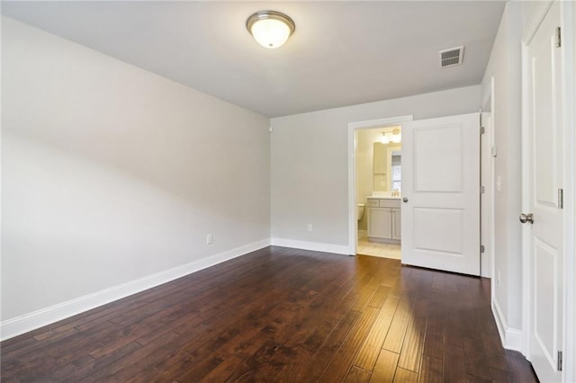 spare room with dark hardwood / wood-style floors