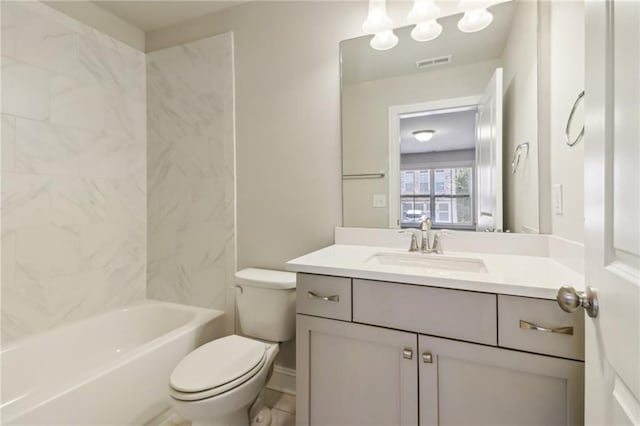 full bathroom featuring toilet, tiled shower / bath combo, and vanity