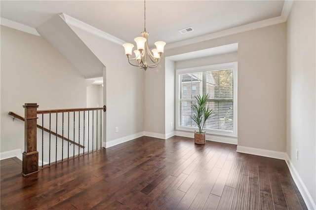 empty room featuring crown molding, a notable chandelier, and dark hardwood / wood-style floors