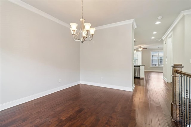 empty room featuring ceiling fan with notable chandelier, crown molding, and dark hardwood / wood-style floors