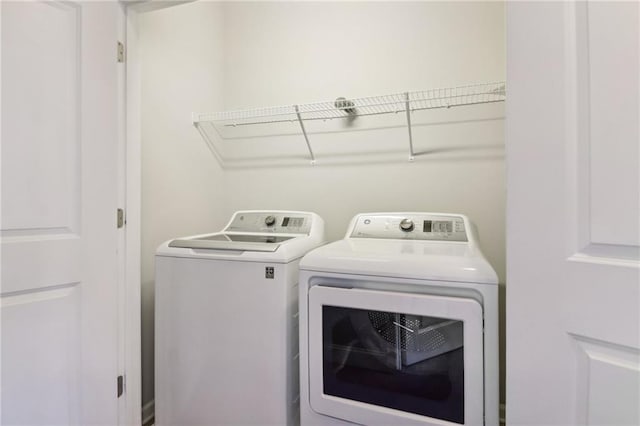 clothes washing area with washer and dryer