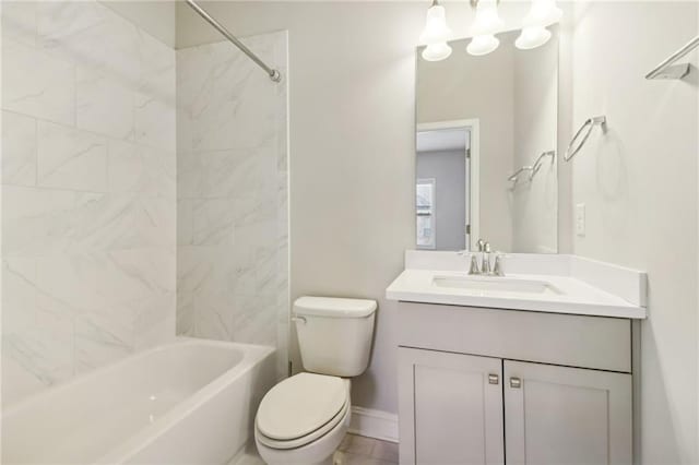 full bathroom with vanity, tiled shower / bath combo, and toilet