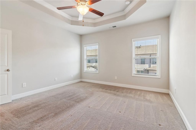 spare room with light carpet, a healthy amount of sunlight, and ceiling fan