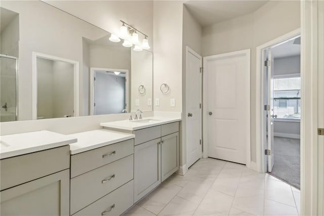 bathroom with vanity and a shower with shower door