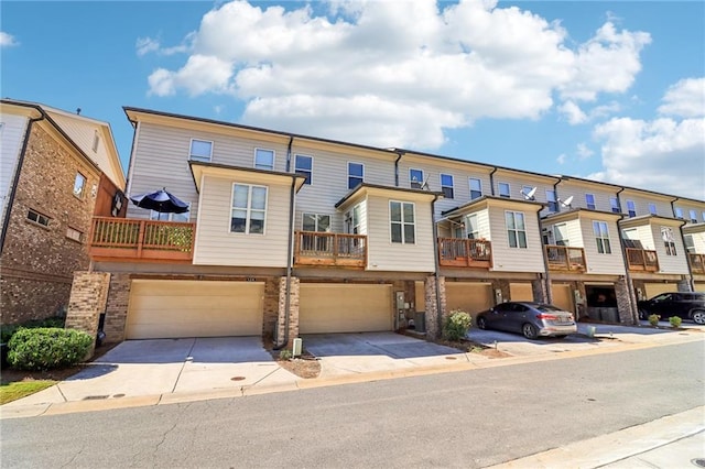 view of property with a balcony and a garage