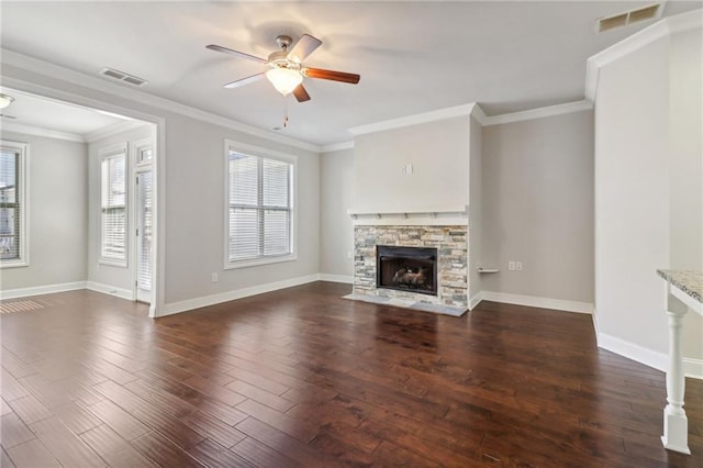 unfurnished living room featuring ceiling fan, a fireplace, ornamental molding, and dark hardwood / wood-style floors