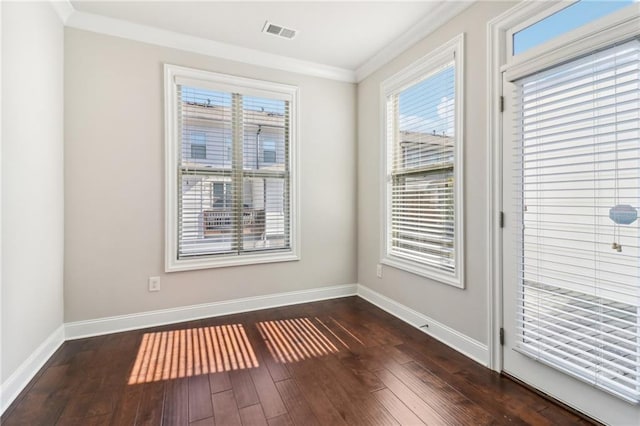 empty room with ornamental molding and dark hardwood / wood-style flooring