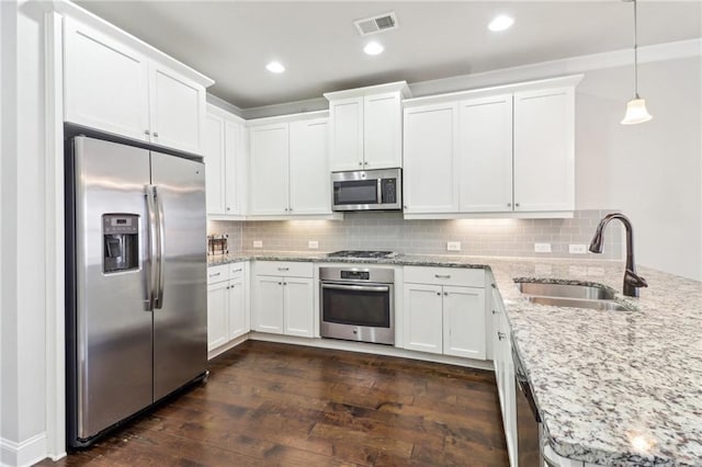 kitchen featuring appliances with stainless steel finishes, white cabinets, sink, and dark hardwood / wood-style flooring