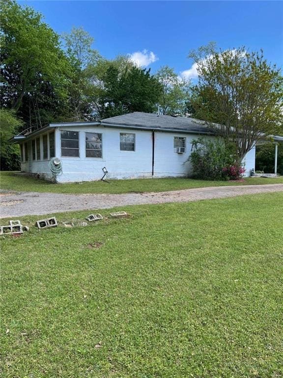 view of home's exterior with a lawn