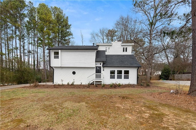 back of house featuring a lawn