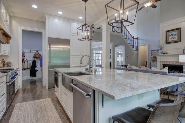 16 Cambridge Way, Cartersville, GA 30121 - kitchen featuring high end appliances, a chandelier, white cabinets, a kitchen island with sink, and recessed lighting