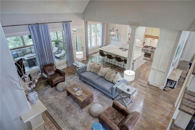 16 Cambridge Way, Cartersville, GA 30121 - living area featuring lofted ceiling, decorative columns, light wood-style floors, and a chandelier