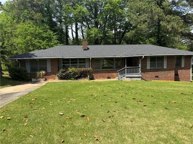 single story home featuring a chimney, a front lawn, crawl space, and brick siding