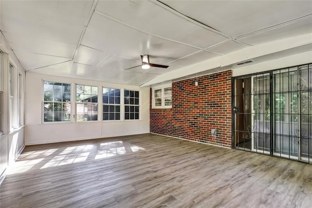 3137 Ardley Rd SW, Atlanta, GA 30311 - unfurnished sunroom featuring brick wall, wood finished floors, and a wooden deck