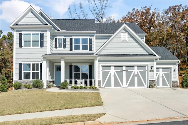 craftsman-style home with a porch, a garage, and a front yard