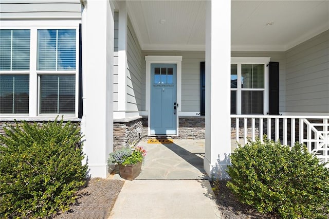 view of exterior entry featuring a porch