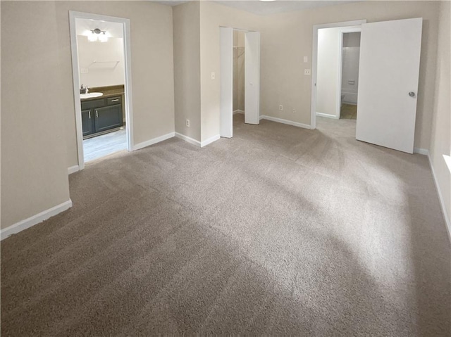 1097 Rock Creek Ln, Norcross, GA 30093 - unfurnished bedroom with connected bathroom, carpet flooring, sink, and a closet