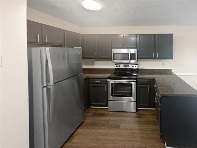 kitchen featuring dark hardwood / wood-style floors and stainless steel appliances