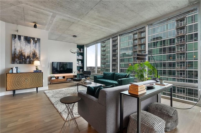 living room featuring hardwood / wood-style floors, expansive windows, and a chandelier