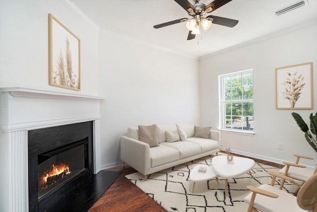 277 Ralph David Abernathy Blvd SW, Atlanta, GA 30312 - living room featuring wood finished floors, baseboards, a glass covered fireplace, crown molding, and a ceiling fan