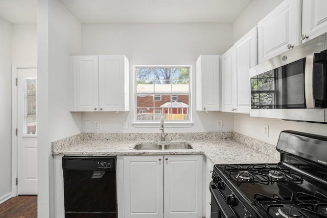 277 Ralph David Abernathy Blvd SW, Atlanta, GA 30312 - kitchen with black appliances, a sink, and white cabinetry
