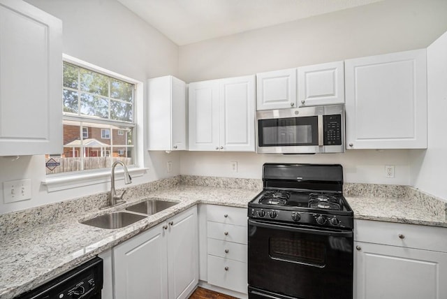 277 Ralph David Abernathy Blvd SW, Atlanta, GA 30312 - kitchen with black appliances, a sink, white cabinets, and light stone countertops