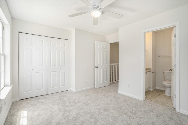 277 Ralph David Abernathy Blvd SW, Atlanta, GA 30312 - unfurnished bedroom featuring carpet, a closet, connected bathroom, baseboards, and a ceiling fan