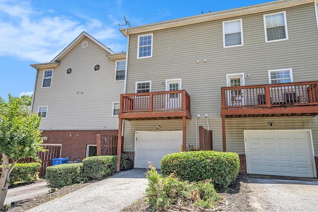 277 Ralph David Abernathy Blvd SW, Atlanta, GA 30312 - back of property with an attached garage, driveway, brick siding, and a balcony