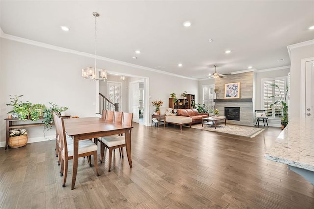 993 Harvest Park Ln, Suwanee, GA 30024 - dining room with a chandelier, wood finished floors, a fireplace, recessed lighting, and ornamental molding