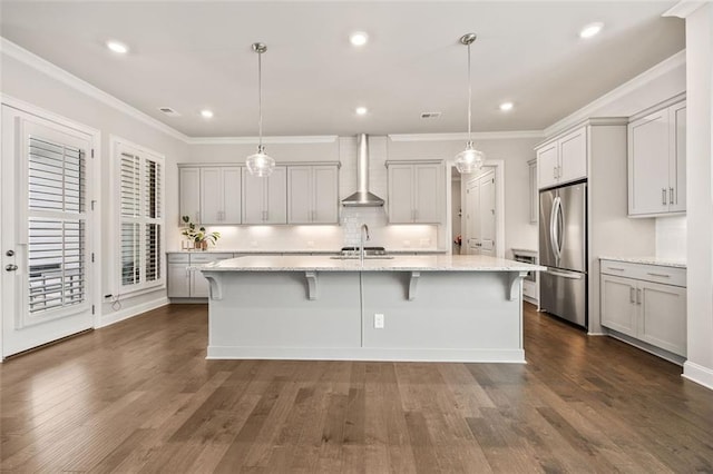 993 Harvest Park Ln, Suwanee, GA 30024 - kitchen featuring wall chimney range hood, freestanding refrigerator, a sink, dark wood-type flooring, and ornamental molding