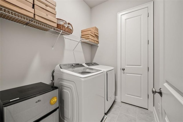 993 Harvest Park Ln, Suwanee, GA 30024 - laundry area with washing machine and clothes dryer and light tile patterned flooring