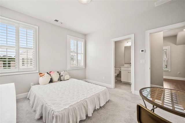 993 Harvest Park Ln, Suwanee, GA 30024 - bedroom with baseboards, ensuite bath, and light colored carpet
