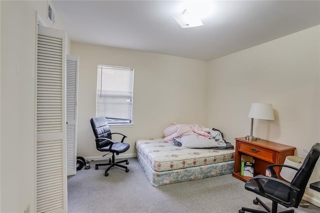 bedroom featuring light colored carpet