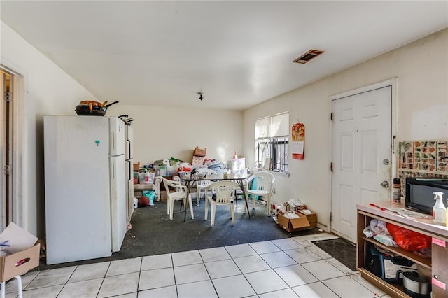 dining space featuring light tile floors