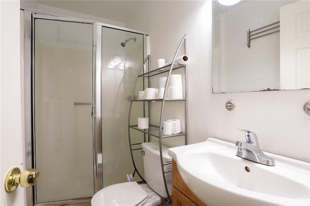 bathroom featuring toilet, walk in shower, and vanity