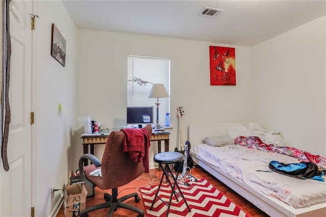 bedroom with dark wood-type flooring